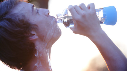 Athlete drinking water pouring all over himself