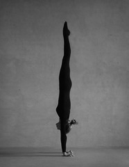 Flexible gymnast posing in black clothes