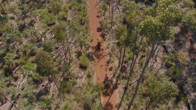 Bike touring through Western Australian bush Munda Biddi Trail Overhead Aerial Drone Panning Shot