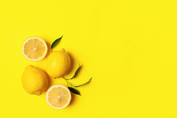 Fresh juicy lemon on a bright yellow background. Concept minimalism. Horizontal frame. Copy space. Flat Layout