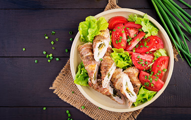 Delicious chicken rolls stuffed with cheese and spinach wrapped in strips of bacon. Top view