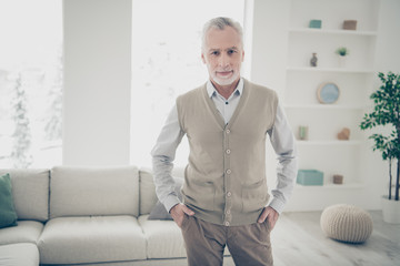 Close up photo amazing he him his aged man wait guests sure cool interior white flat hospitality atmosphere hands arms pockets wear white shirt waistcoat pants comfy bright house living room indoors
