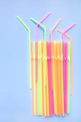 Colourful drinking straws on blue background. Cocktail tubes. Place for your text. Say no plastics. Plastic free concept.