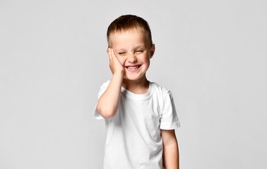 Surprised boy looking at the camera. Beautiful happy child, isolated on white background