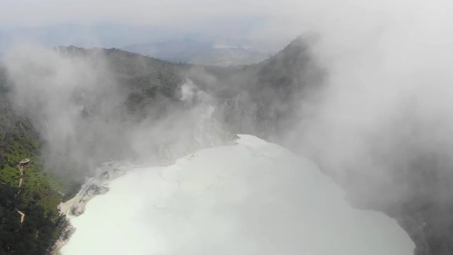 Cinematic aerial view clip of Kawah Putih or White Crater famous of its sulfuric acid lake, located at in Ciwidey, Bandung, Indonesia.