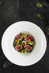 Exquisite Serving White Restaurant Plate of Tuna Fillet Salad with Quail Eggs and Salsa from Sweet Tomatoes Top View