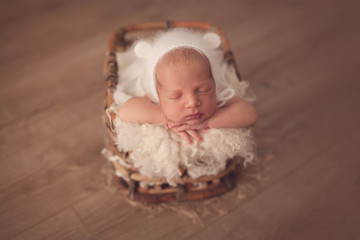 Cute sleeping newborn baby boy in beige color