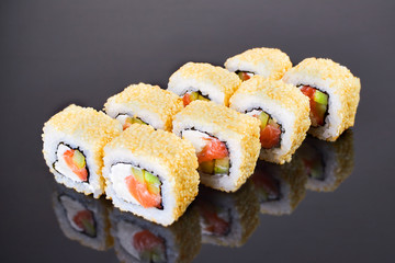 California roll sushi with sesame, salmon, avocado and cream cheese on black background for menu. Japanese food