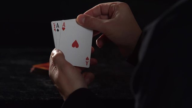 CU SLOW MOTION: Five card draw poker player reveals Ace in hand, slowly uncovers remaining cards to show full house - Kings over Aces