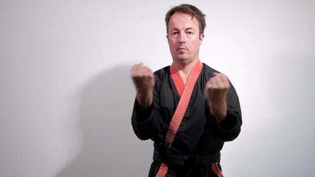 Black belt karate expert performs a martial arts kata.