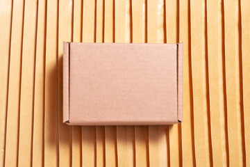 Brown cardboard box on lot of bubble envelopes
