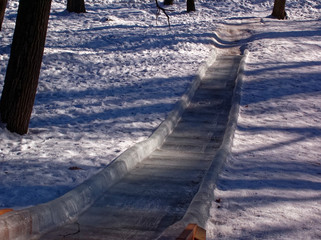 wooden slide for descent in the Park in winter