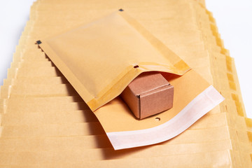 Brown cardboard box inside of bubble envelope