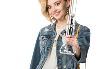 selective focus of stylish hippie girl holding bong isolated on white