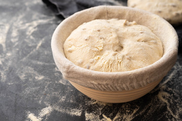 Balls of dough covered with wheat flour ready for baking. Copy space.