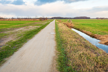 Fototapeta na wymiar Seemingly endless straight path in a rural landscape