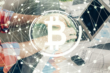 Crypto currency theme hologram with businessman working on computer on background. Concept of blockchain. Double exposure.