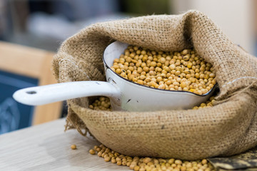 Soybean In sacks on wooden background