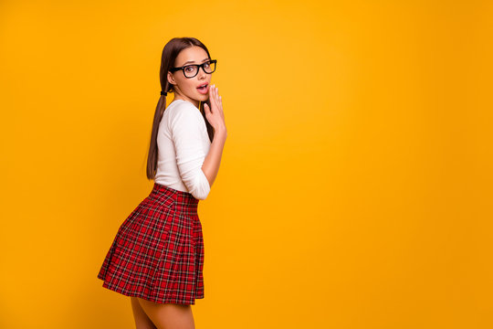 Profile side view portrait of her she nice attractive winsome lovely glamorous impressed cheerful girl wearing eyeglasses eyewear having fun isolated over bright vivid shine yellow background