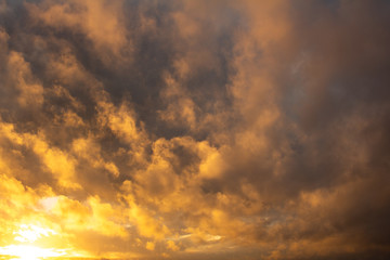 Naklejka na ściany i meble Storm clouds illuminated by the sunset sun. Free space.