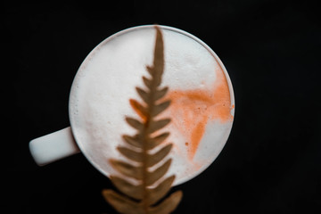 cup of coffee with fern