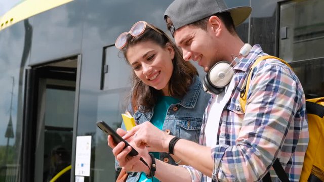 Portrait girl helping lost male tourist to find way.