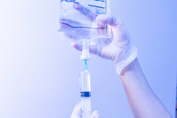 Syringe package with saline composition first aid concept blue tone close up