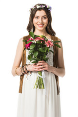 front view of pregnant hippie woman in wreath holding flowers isolated on white