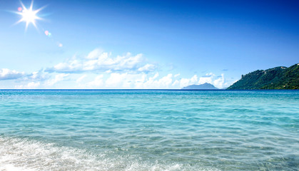 Summer background of beach and ocean and blue skyh. Sunny hot day 