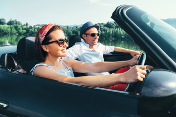 Couple in love ride in cabriolet car