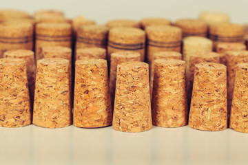 Heap of assorted wine corks on wooden background
