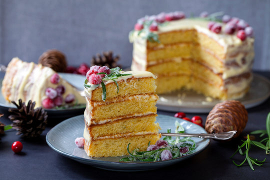 Layered Christmas cake with sugared cranberries and rosemary