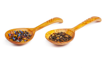 Dried tea on a wooden spoon, isolated on white
