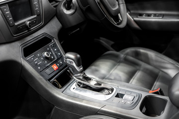 Fototapeta na wymiar Gear Lever or Shift Lever with cup holder and air condition control in modern car.