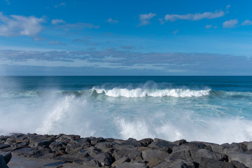 Big waves crashing over black volcanic rock on the Atlantic Ocean in the coast of Sao Miguel island in the Azores, Portugal