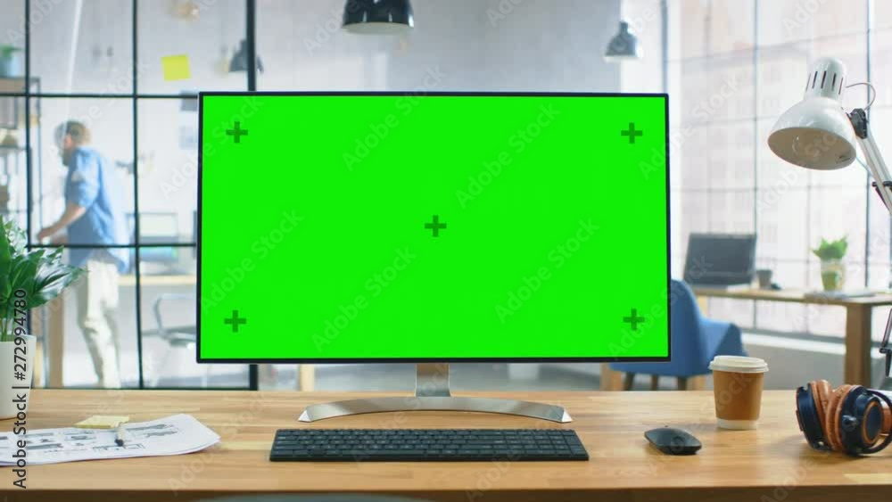 Aufkleber Wide Green Mock-up Screen Desktop Computer Standing on the Desk in the Modern Creative Office. In the Background Bright Creative Loft for Developers and Designers where Professional Working. Zoom In 
