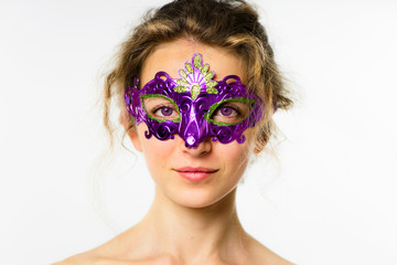 face of a pretty girl in carnival mask