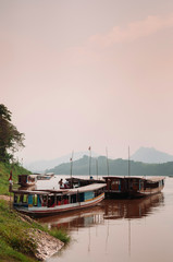 Luang Prabang, Laos - Vintage wooden boats at Mekong river shore