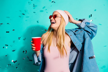 Portrait of her she nice charming cute attractive fascinating cheerful cheery glad positive girl holding in hand red cup flying decor isolated on bright vivid shine blue green turquoise background