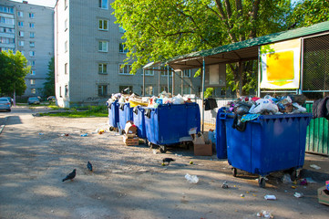 blue containers with garbage, boxes, bags and plastic