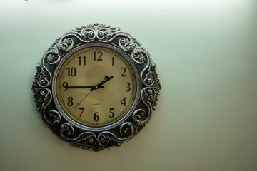 Ancient Wall Designer Wall Clock With Light Yellow Back Ground showing time 01:45 o'clock