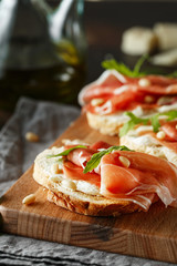 Traditional parma cured ham antipasto. Bruschetta set with Parma Ham and Parmesan Cheese. Small...