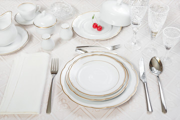 Two cherries lie on a white porcelain plate