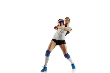 Fototapeta na wymiar Young female volleyball player isolated on white studio background. Woman in sport's equipment and shoes or sneakers training and practicing. Concept of sport, healthy lifestyle, motion and movement.