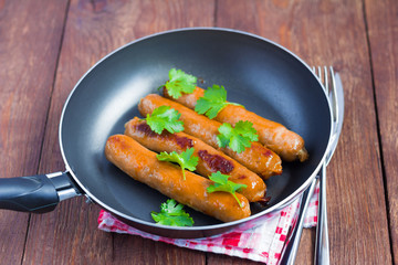 delicious pork sausages with greens, fried in a pan