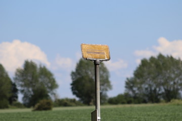 Old busstop sign on the field
