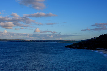 St Ives City during sunset. St Ives is a seaside town, civil parish and port in Cornwall, UK. The town lies north of Penzance and west of Camborne on the coast of the Celtic Sea