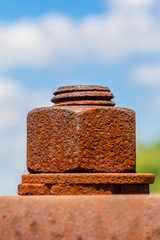 Rusty Bolt and Nut in a Metal Plate