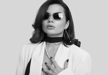 Attractive elegant woman with dark hair in fashion white suit