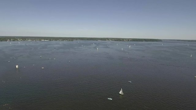 Top down view of motorboat doing circles and leaving white foam tracks on the river. Aerial view of motor boats sailing on the river.  4k shot drone 